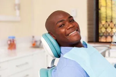 man smiling in the dental chair at Dynamic Dental